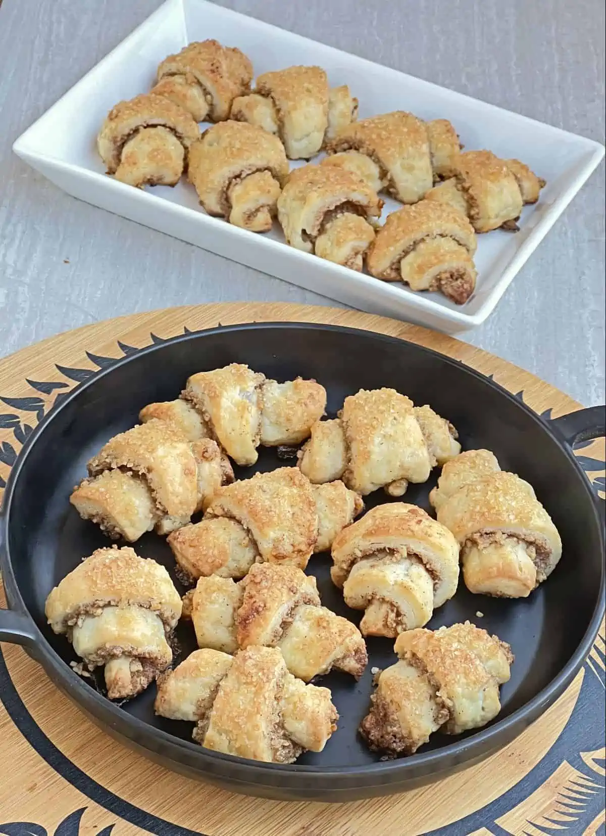 pastries in a black plate and in a white plate in the background