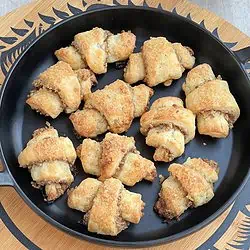 shaped and filled cookies on a black plate.