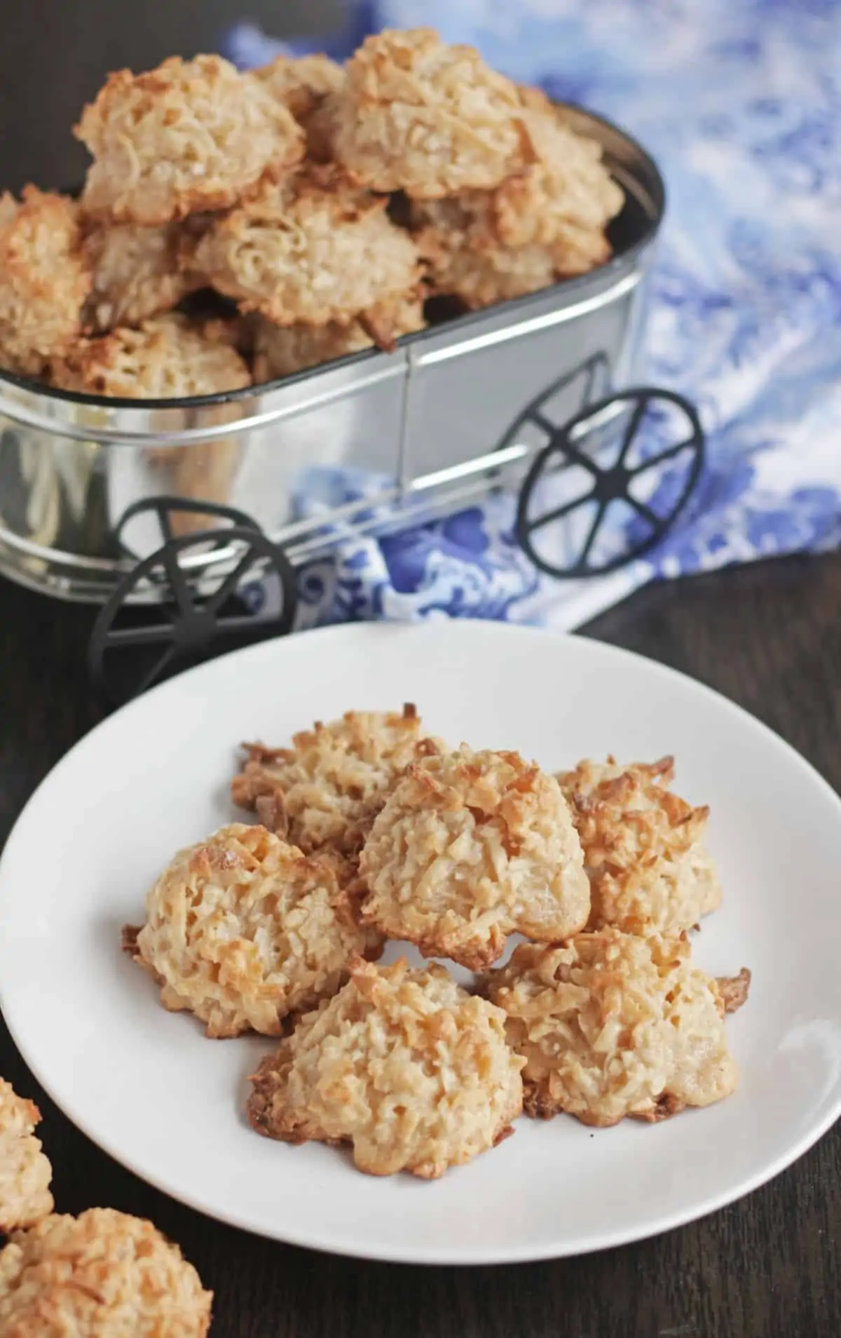 coconut macaroons on a pate and in a container in the background