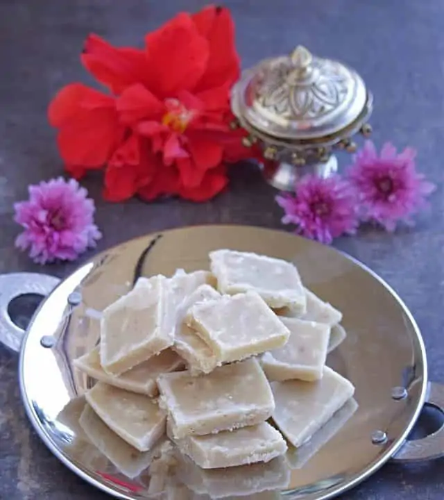 Maida Burfi for Diwali with flowers in the background