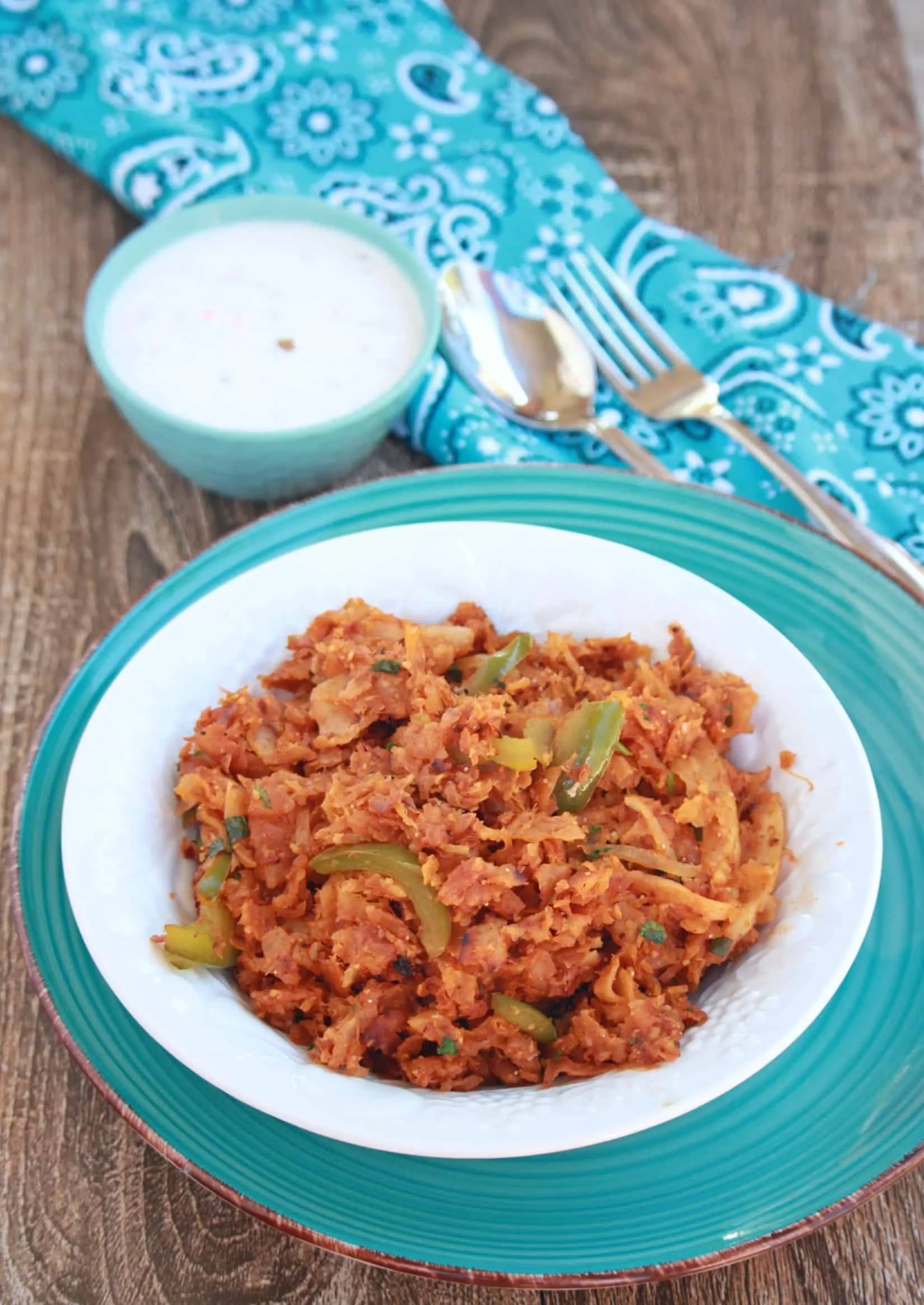 Chili Parotta and yogurt in background.