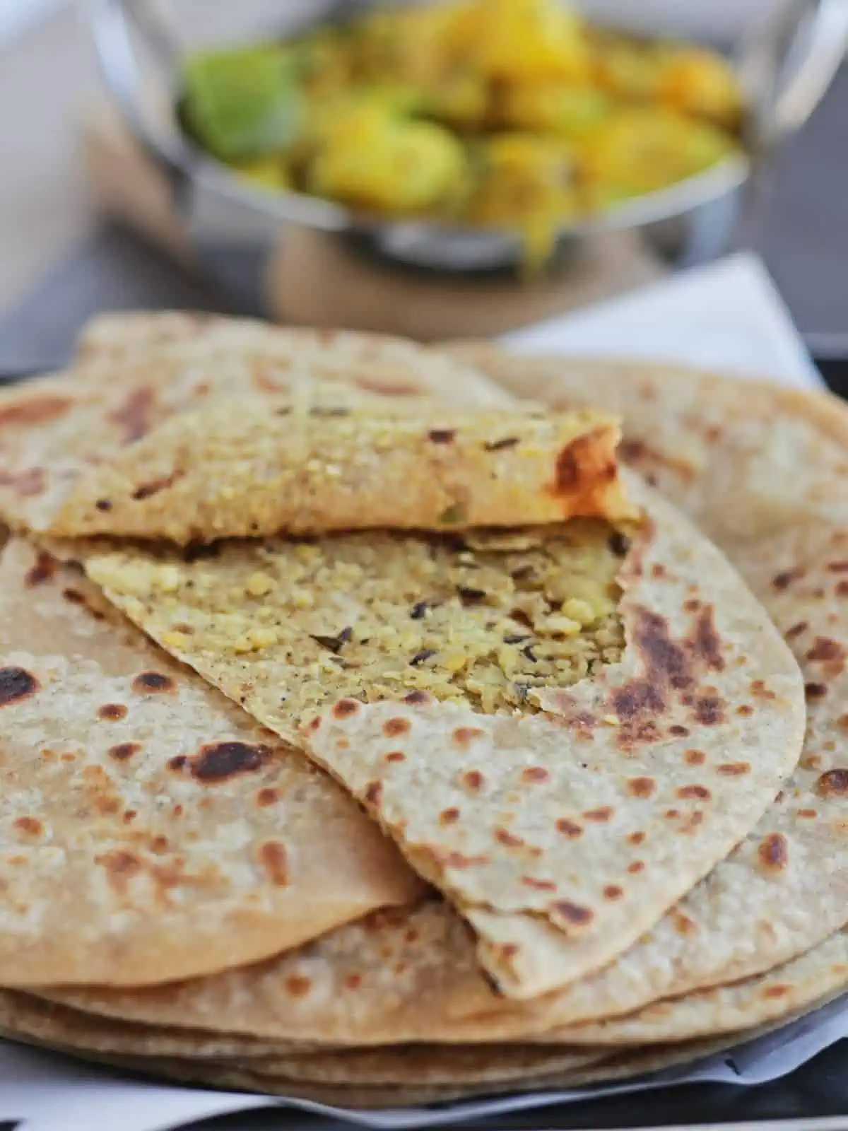 Chana dal paratha split open to show the lentil filling inside.