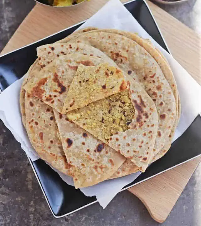 Layers of paratha with the top one showing a stuffed lentil filling.