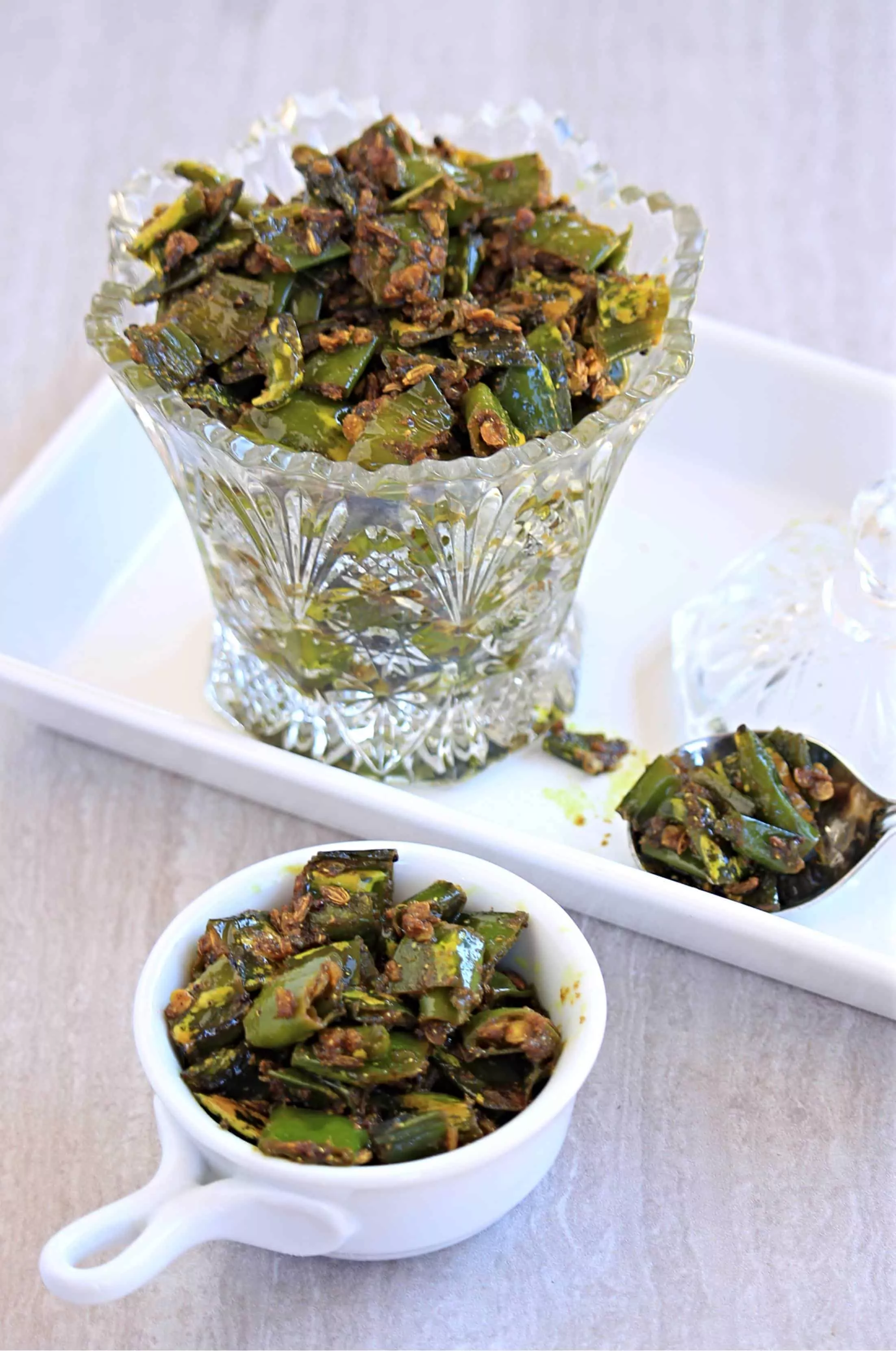 green chili pickle in a bowl and jar