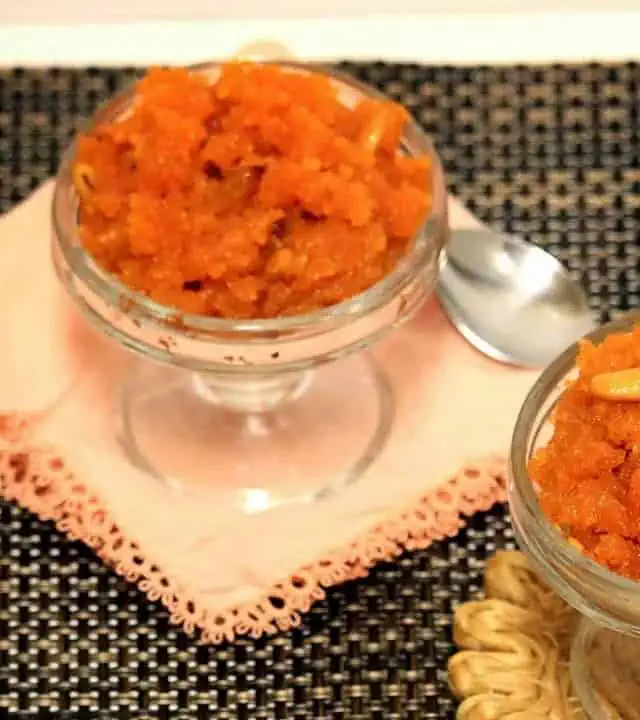 Aval Kesari in 2 glass bowls with spoon on the side.