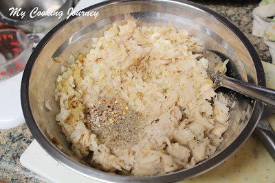 Adding spices to the onion and potato mixture