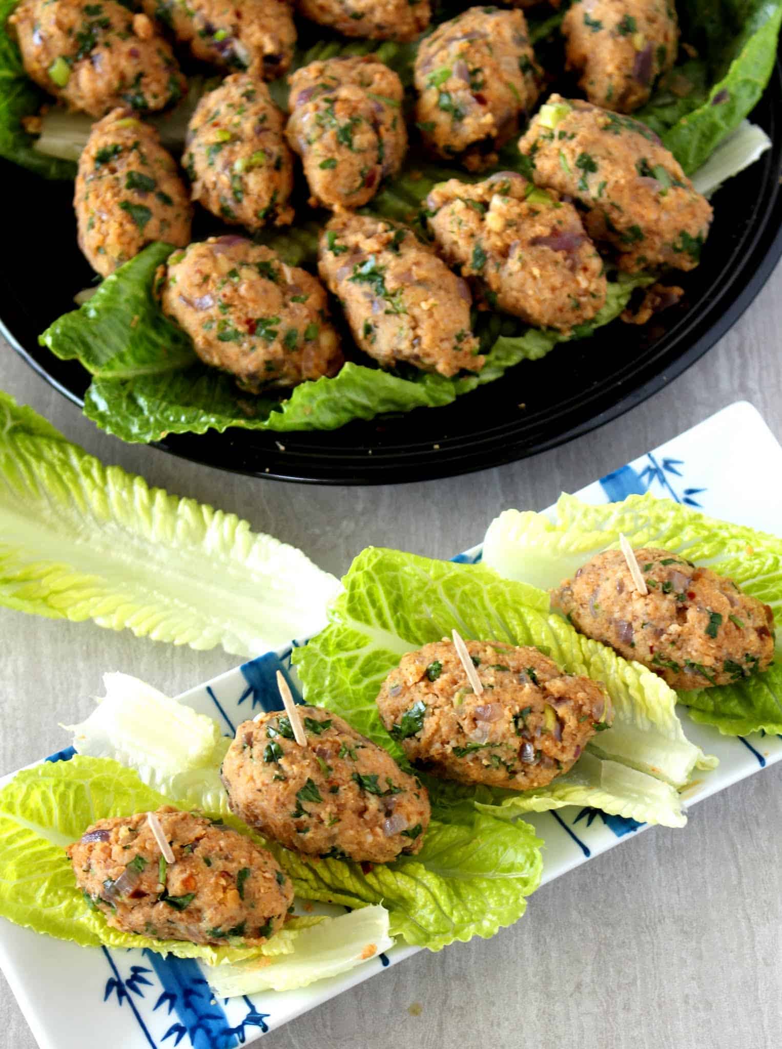 Mercimek Koftesi in lettuce wrap and plate in background