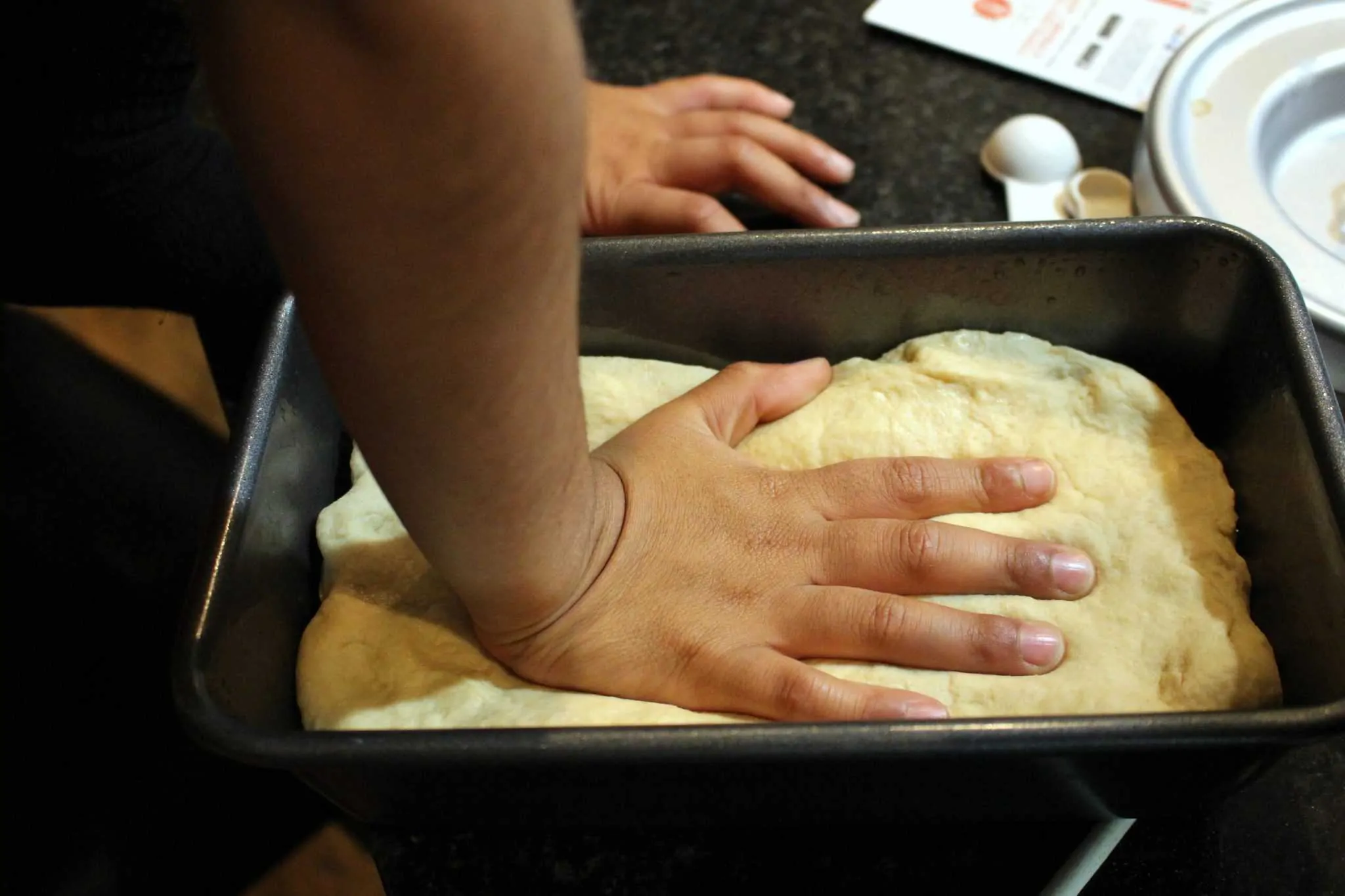 Placing the dough in a loaf pan