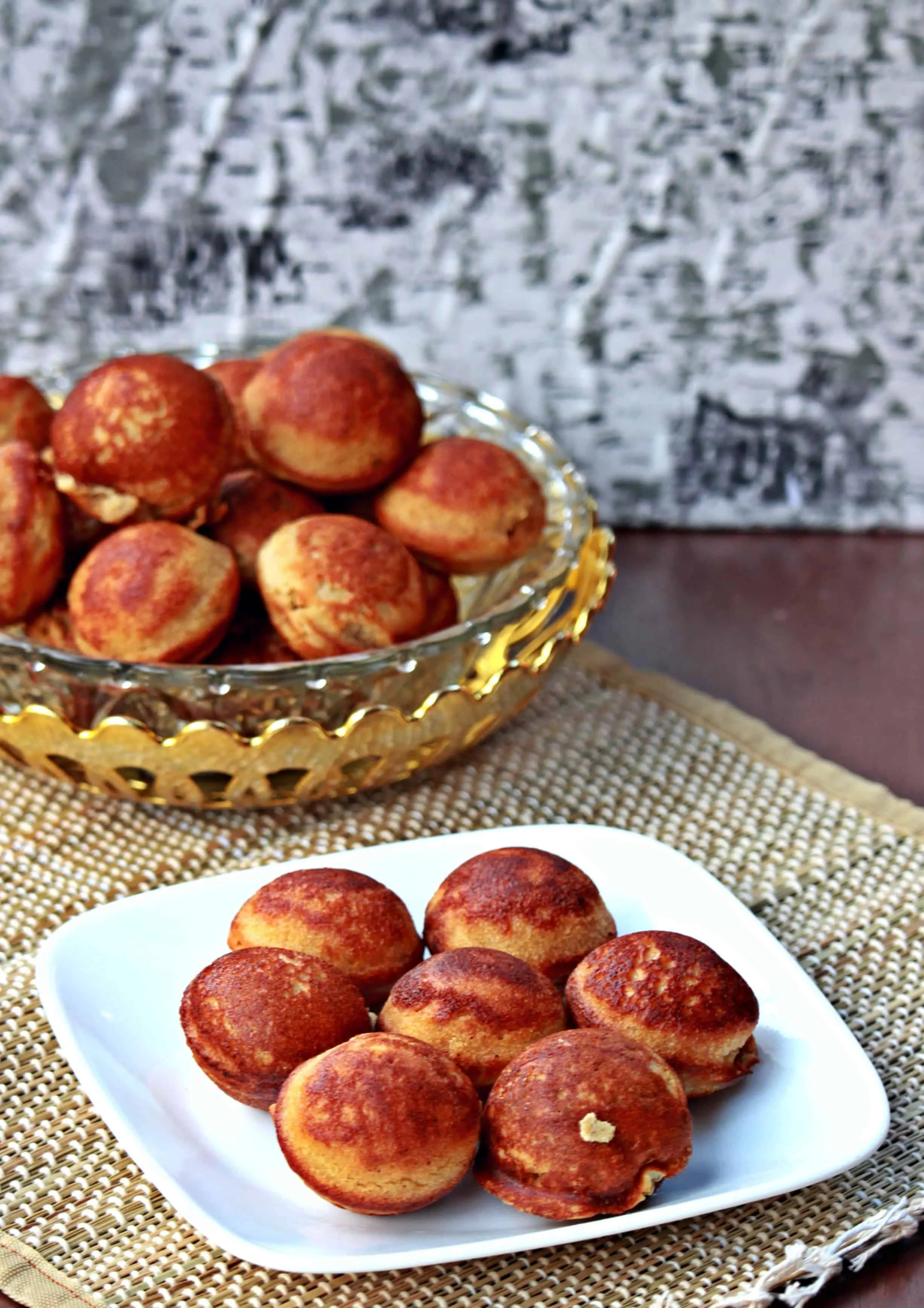 Thinai Sweet Paniyaram in a bowl behind.