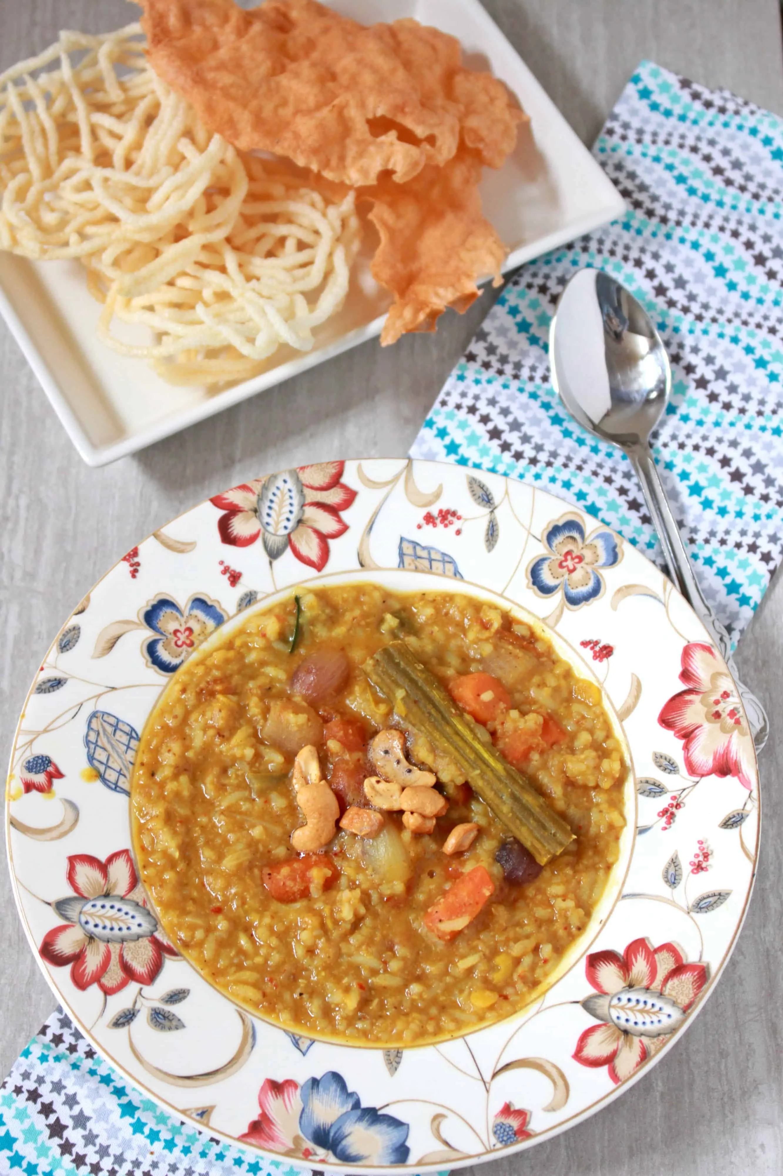 South Indian Sambhar Rice with crackers in background.