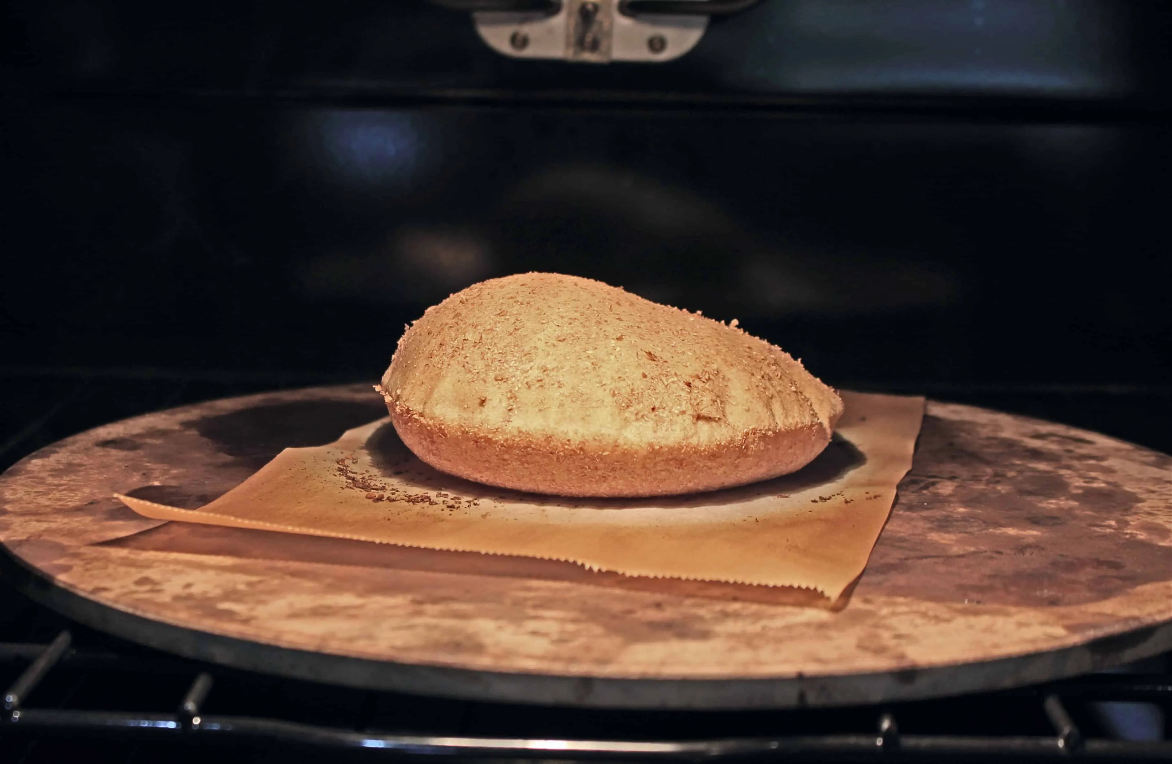 aish baladi flatbread puffing up inside the oven on a pizza stone