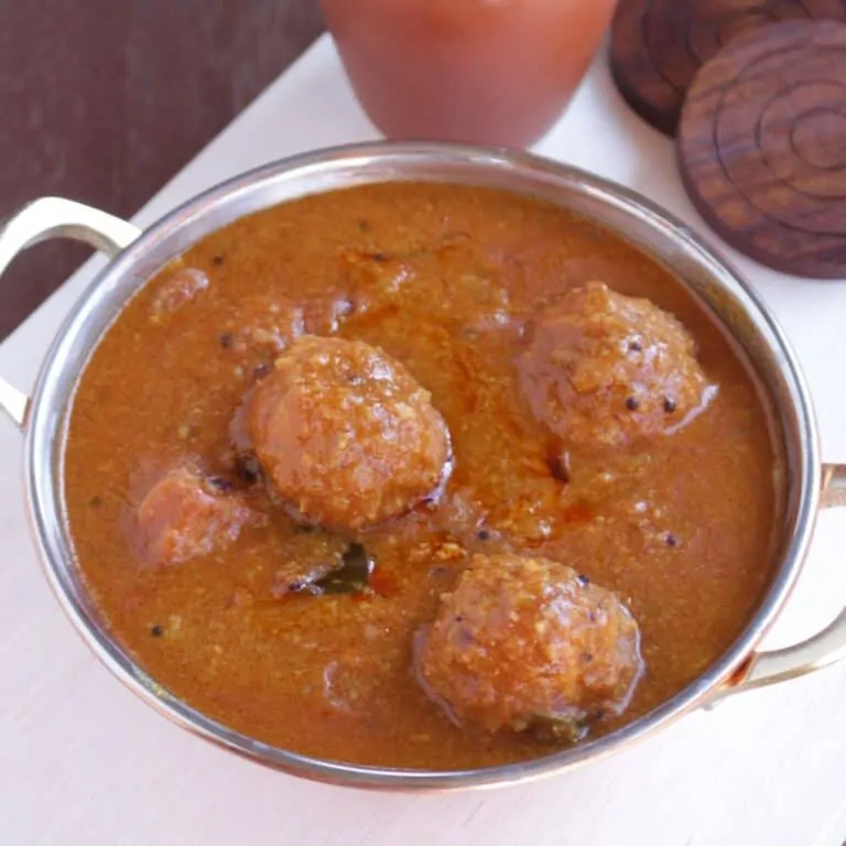 Kuzhambu made with lentil balls in a steel bowl