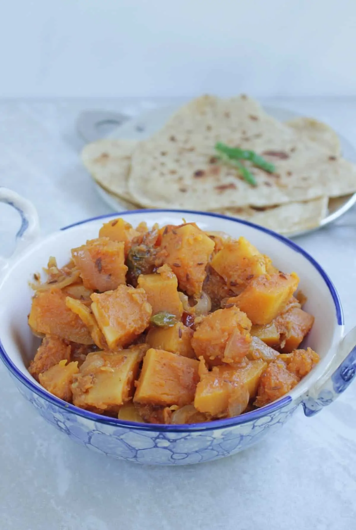 Kaddu ki subzi with roti in the background