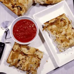 Focaccia with Herbed Oil and Caramelized Onions in a tray