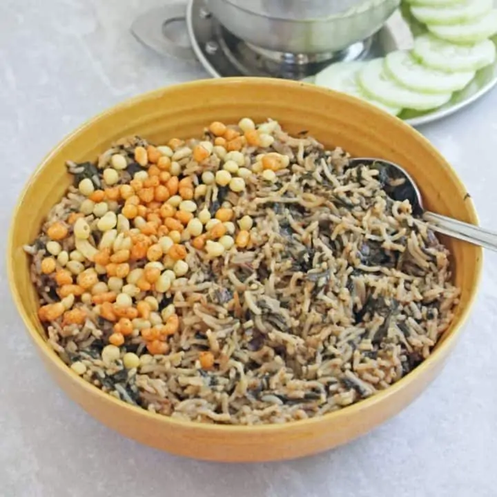 spinach rice in a bowl with spoon