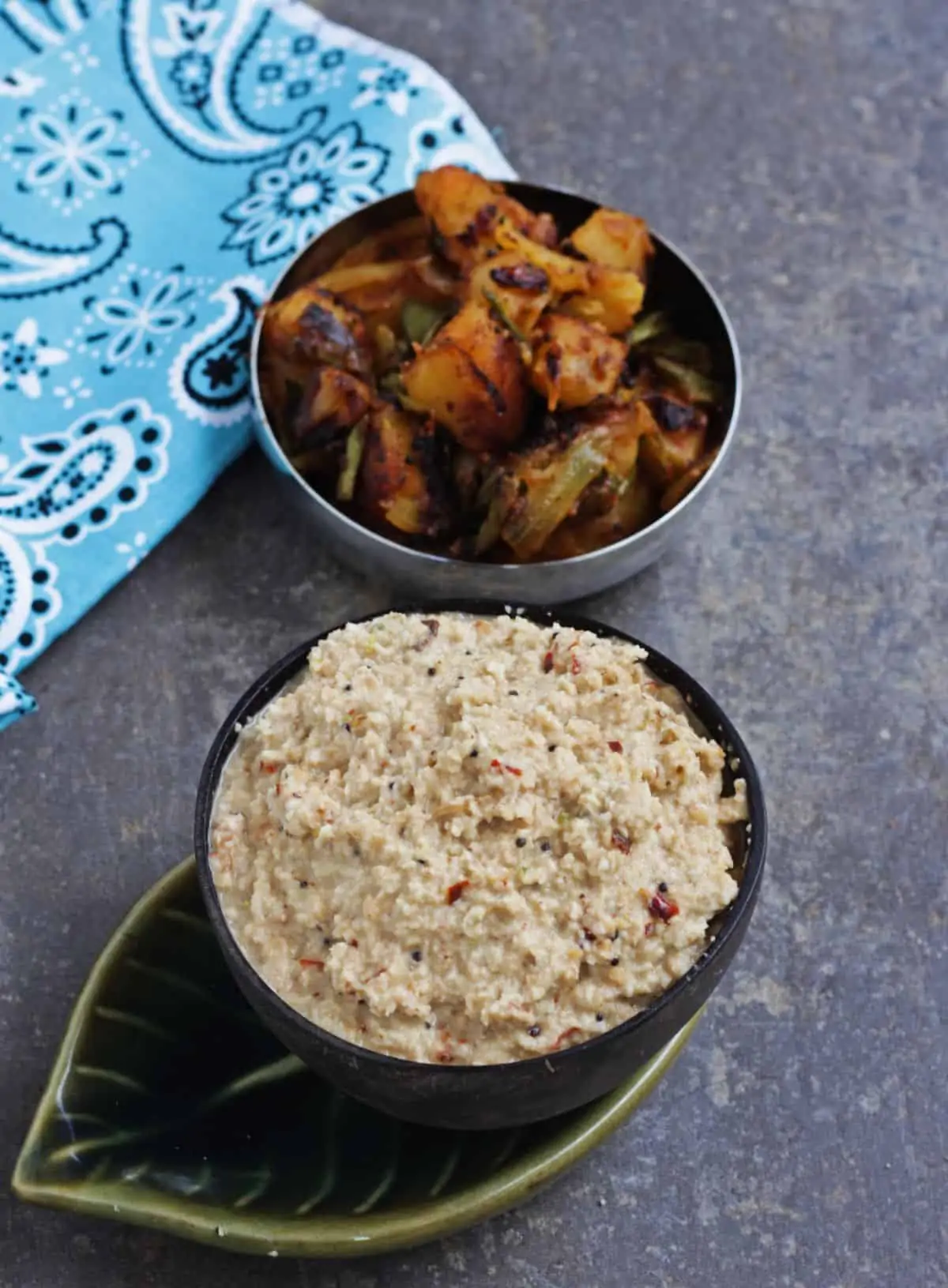 fried coconut chutney in a brown bowl with potato curry on the side