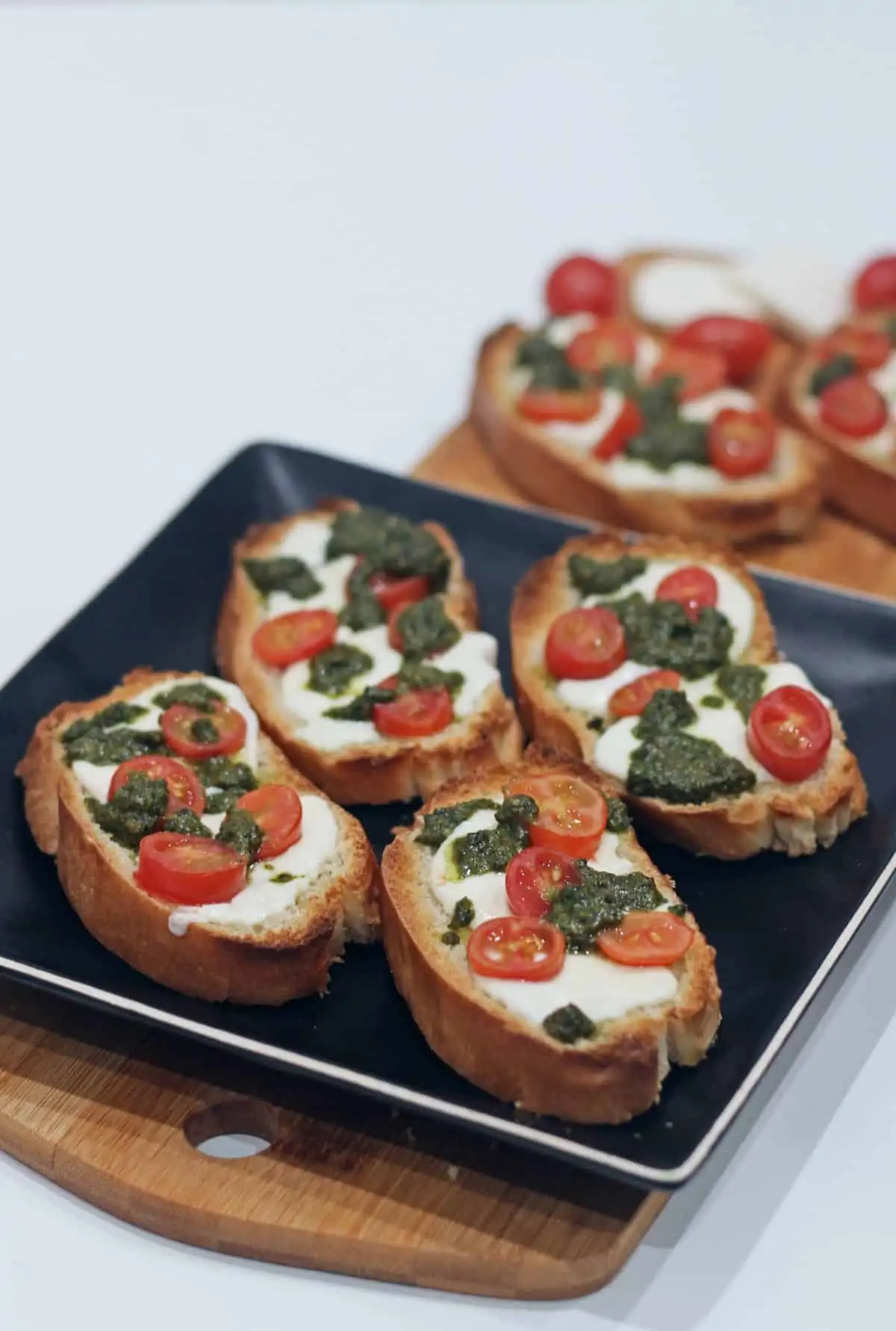 crostini arranged in a black plate