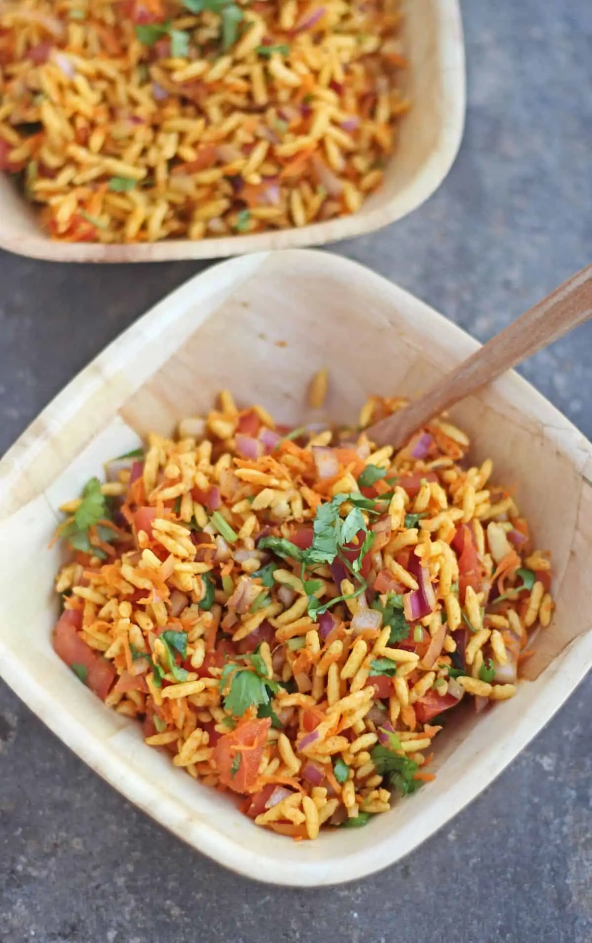 Puffed rice snack with vegetables in a bowl with spoon