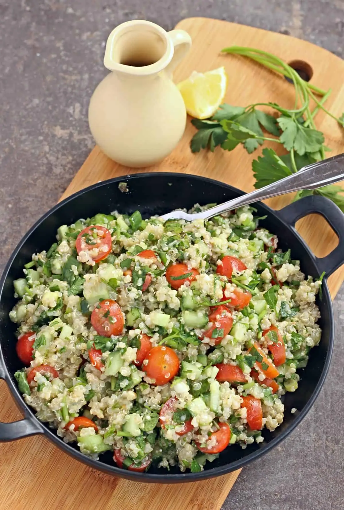 Quinoa tabouli salad in a black plate