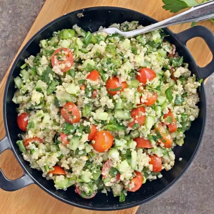 Quinoa Tabbouleh salad in a black plate