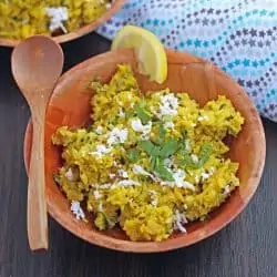 Indore style bhutte ka kees in a bowl with spoon