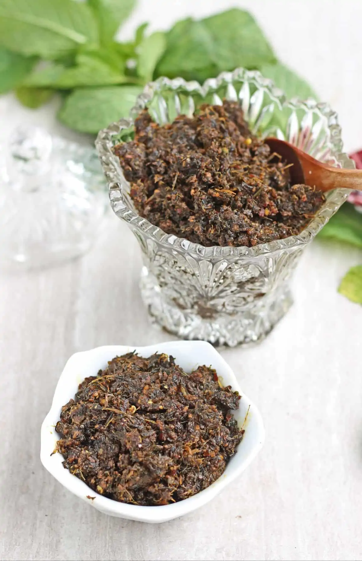 pudina thogayal in a glass jar and a white glass bowl