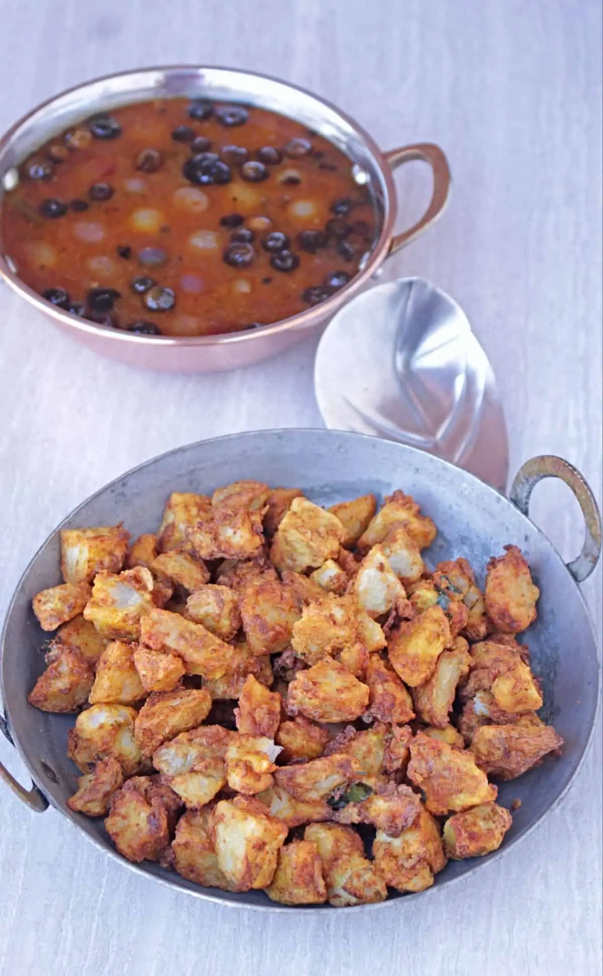 taro root poriyal in a pan with vathal kuzhambu