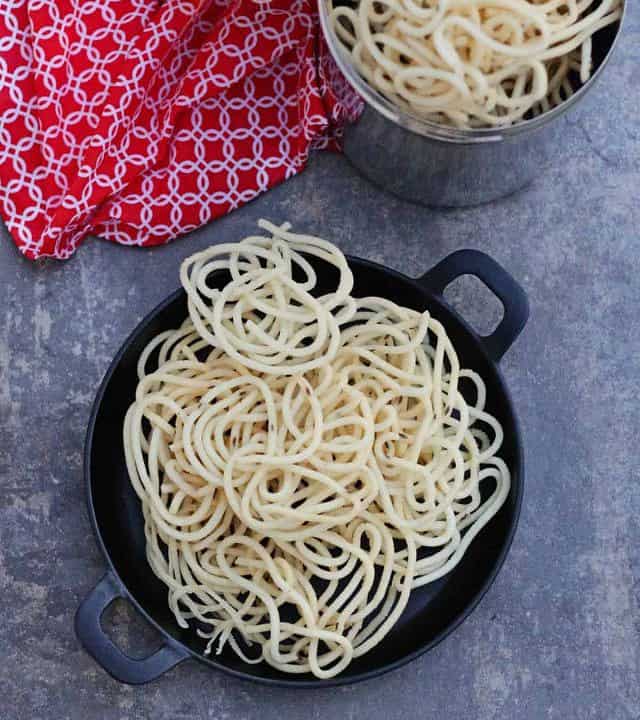 thenkuzhal murukku in a black plate and steel box