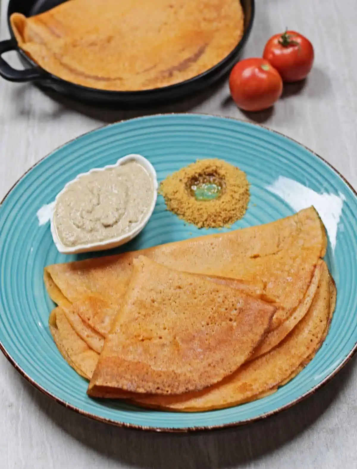 thakkali dosai on a blue plate