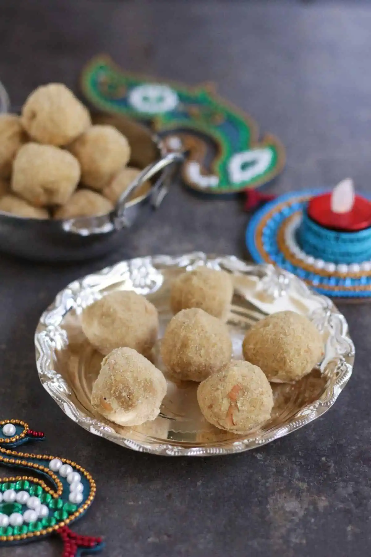 Patham urundai in a silver plate and bowl.