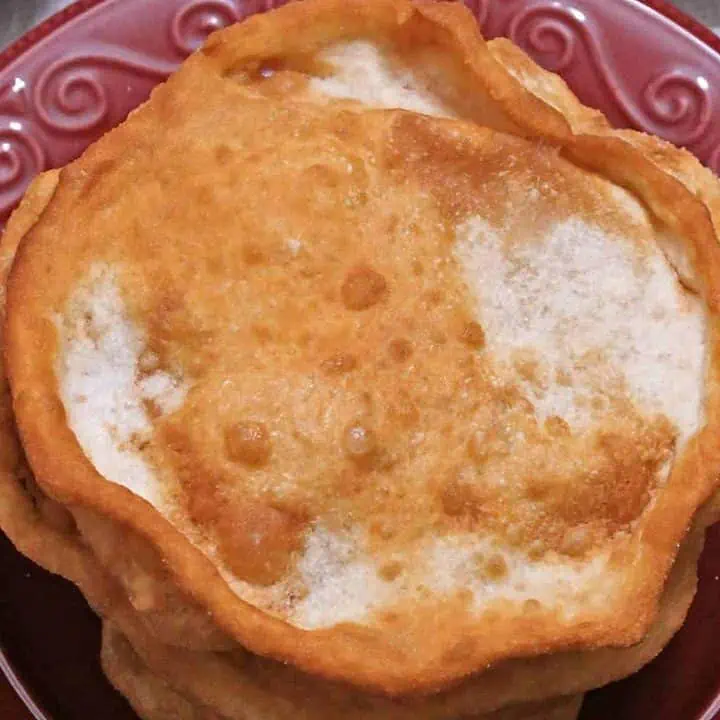 Navajo bread in a red plate - Featured Image