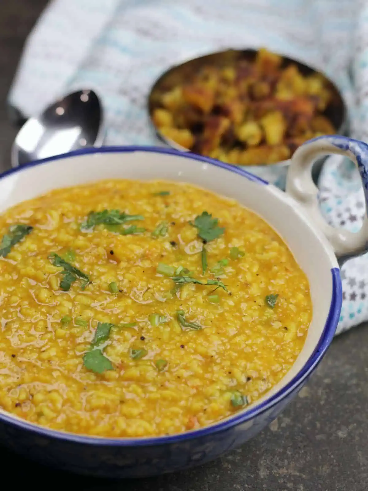 rasam rice with cilantro garnish.