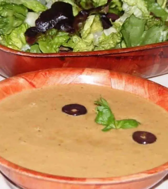 Asian Style salad dressing in a bowl with salad on the side - Featured Image