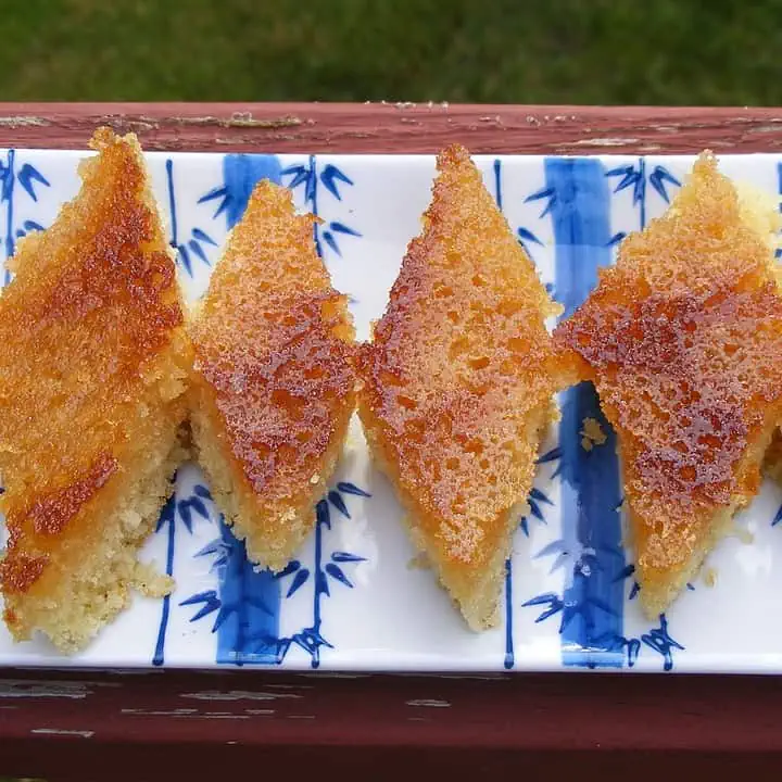 Honey Drizzled Semolina Cake in a white decorative plate - Featured Image