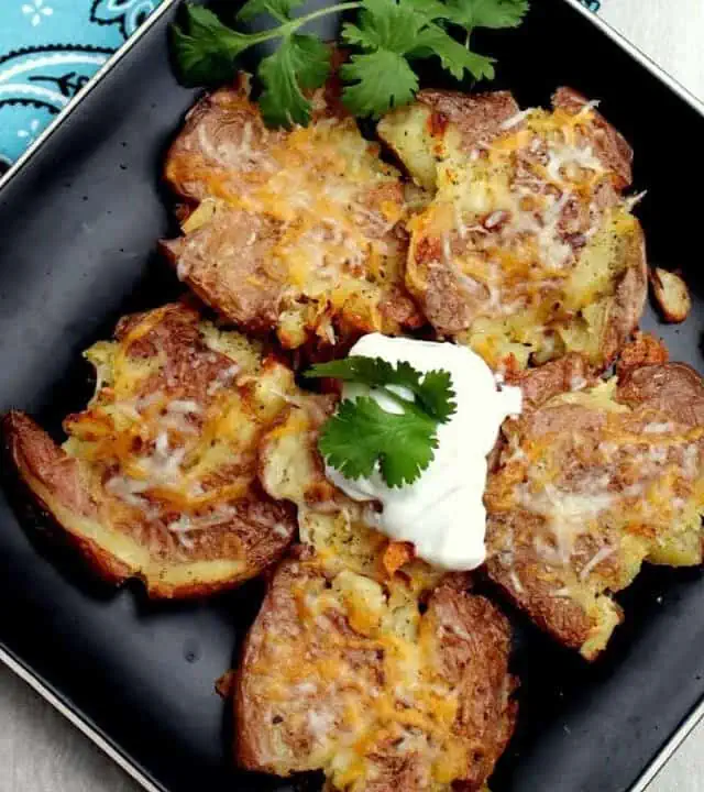 Smashed Potatoes in a black plate - Featured Image