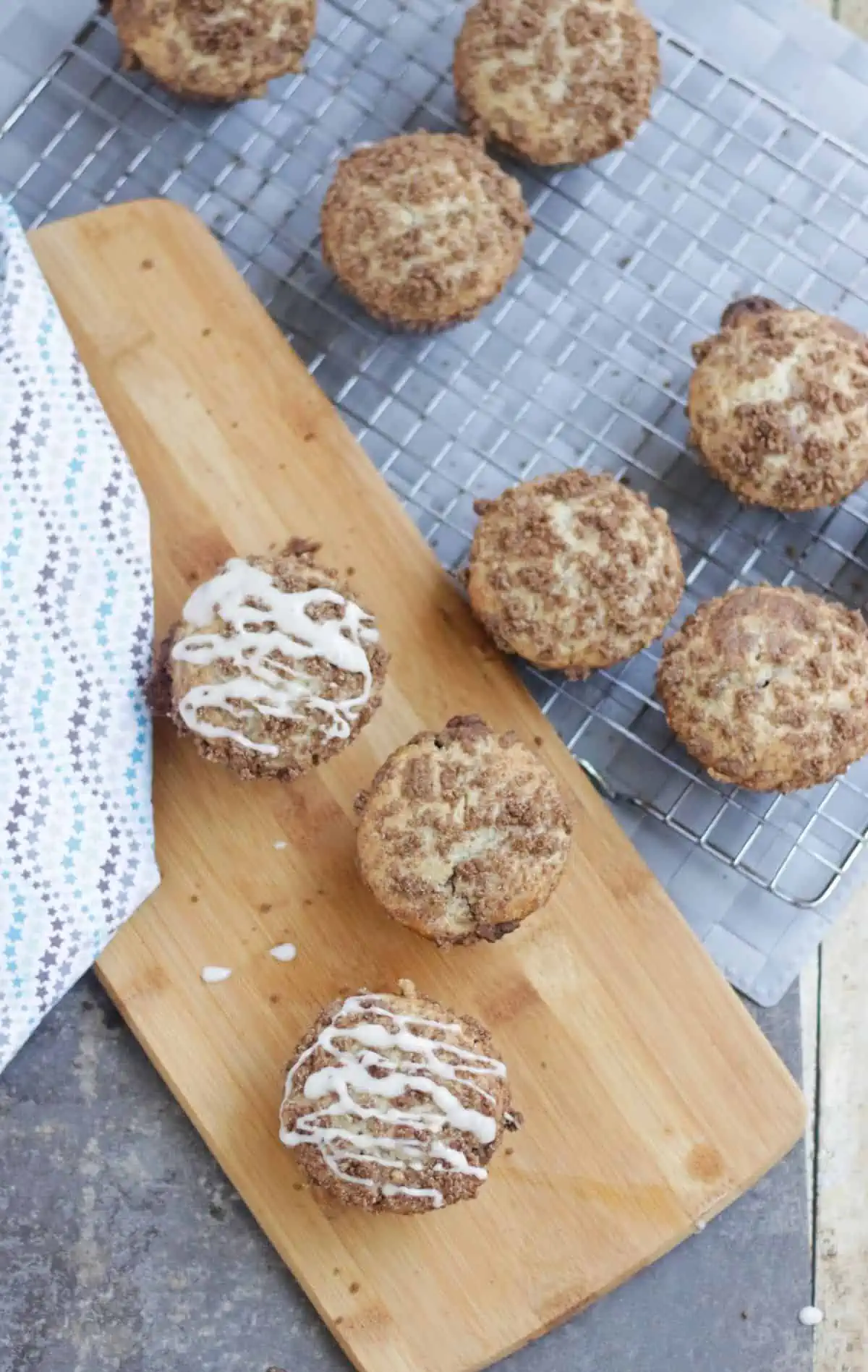 Cinnamon roll muffins in a wooden tray and wire rack. 