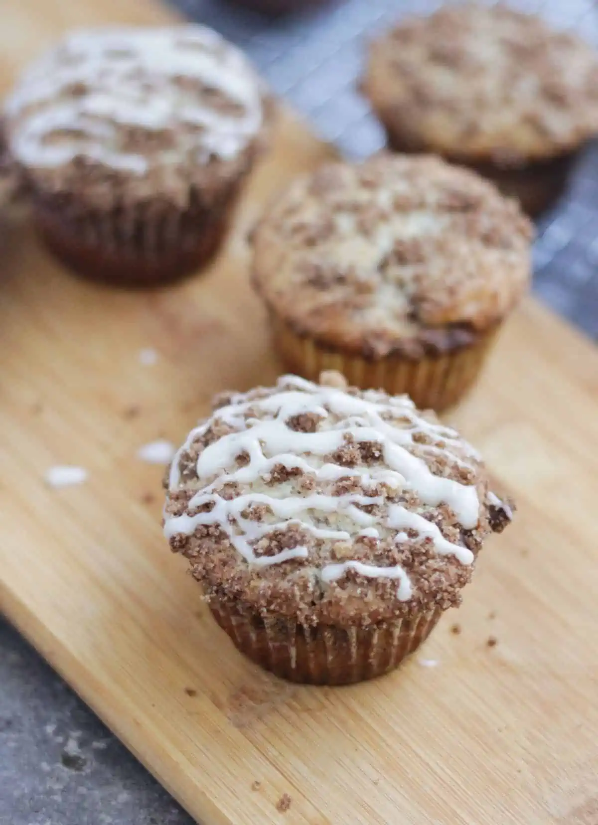 Muffins on a wooden tray.