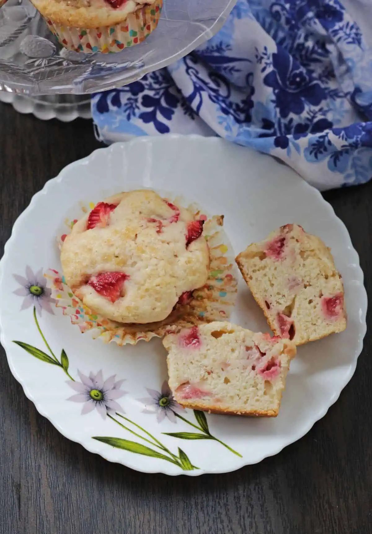 A whole strawberry muffin and a split open one.