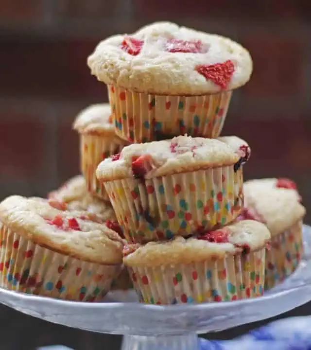 Strawberry muffins stacked in a glass plate.