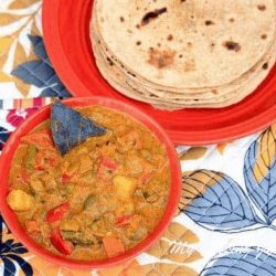 Nilgiris Kurma in a red bowl with roti on side - Feature Image