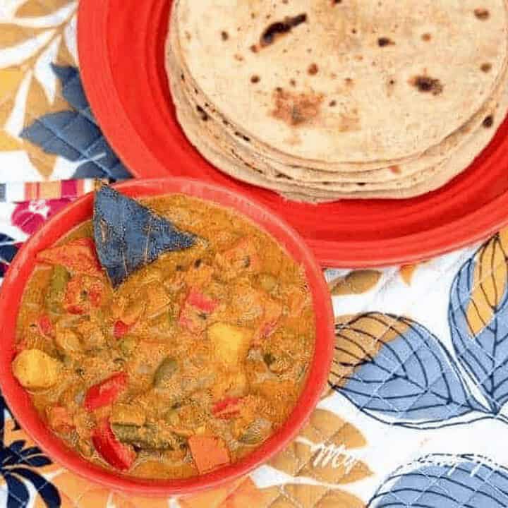 Nilgiris Kurma in a red bowl with roti on side - Feature Image