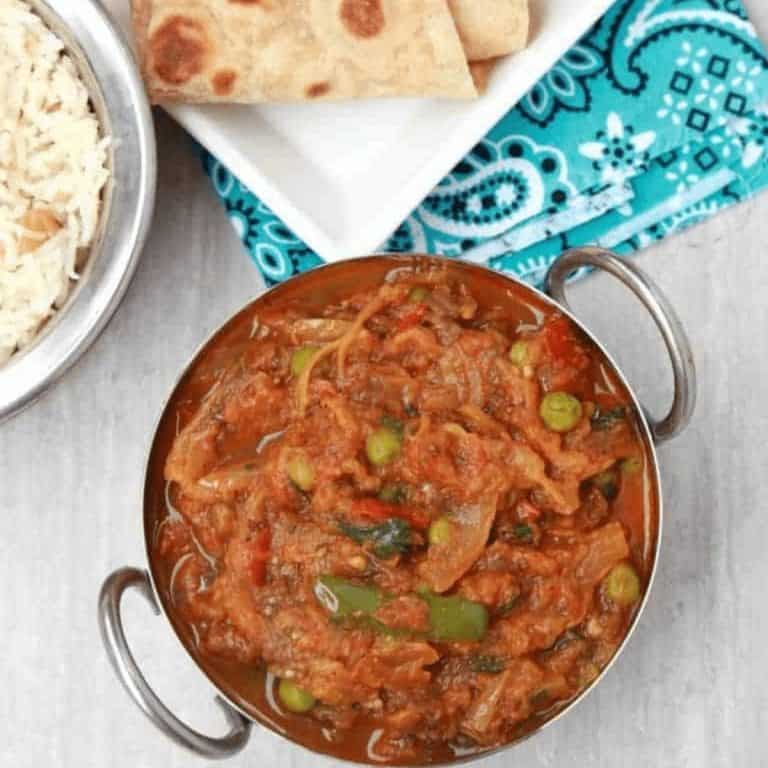 Baingan Bharta in a kadai with roti on the side - Feature Image