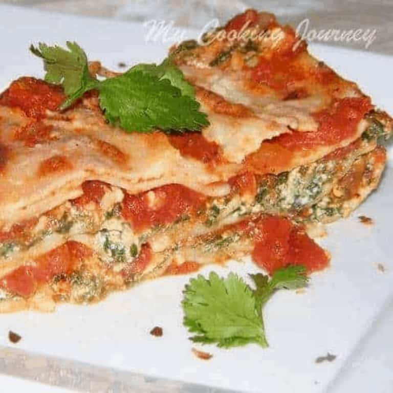 Spinach and Ricotta Lasagna served in a white plate - Feature Image