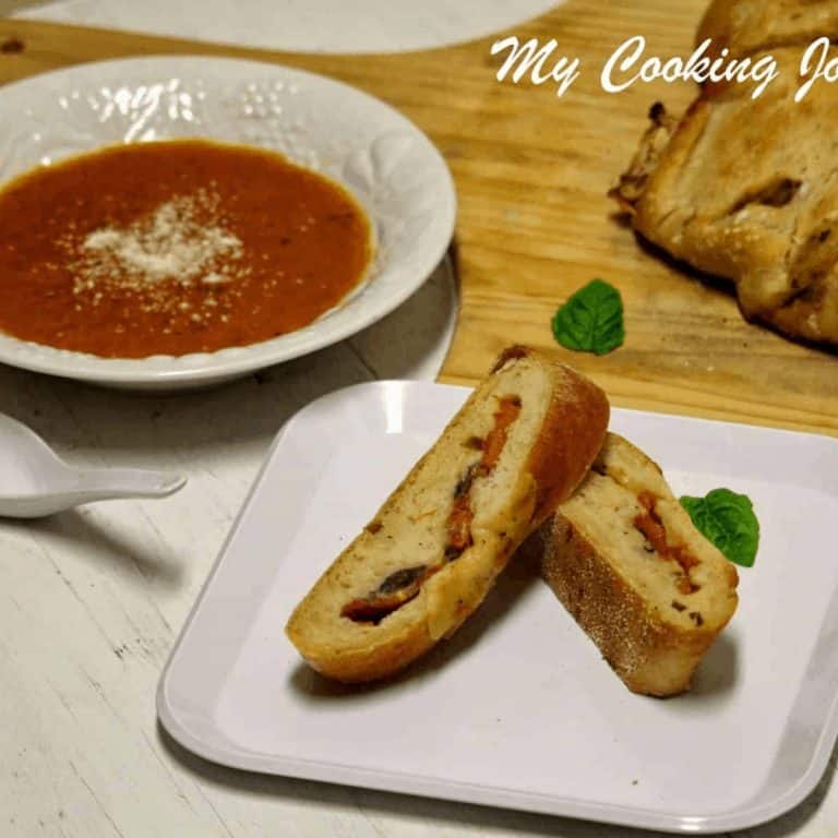 Tomato Mozzarella and Basil Stuffed Baguettes in a white plate - Featured Image